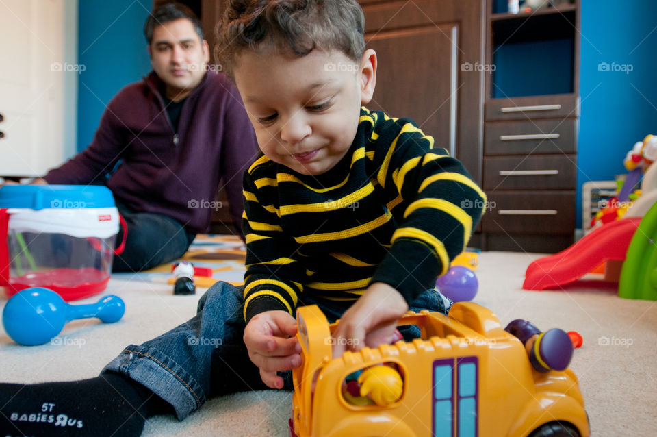 Boy playing with toys in play room