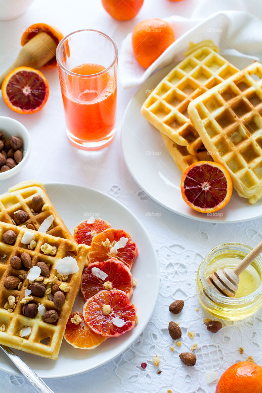 Healthy breakfast. Belgian waffles with blood orange, nuts and coconut