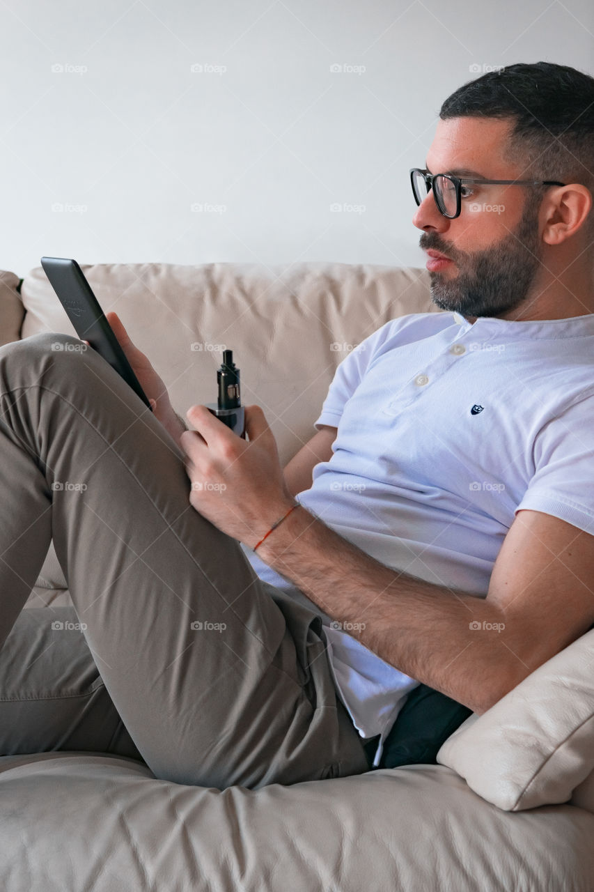 Man smoking while relaxed at home