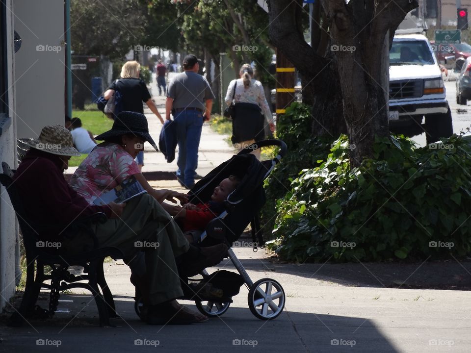 Grandparents With Child In A Stroller