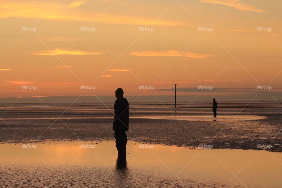 Another place. A photographers dream... A beautiful evening with the sun setting over the Anthony Gormley statues at Crosby beach 
