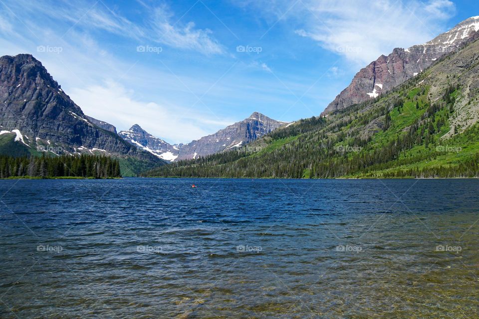 Glacier National Park in northwest Montana features crystal blue waters and jagged peaks formed by glacier movement