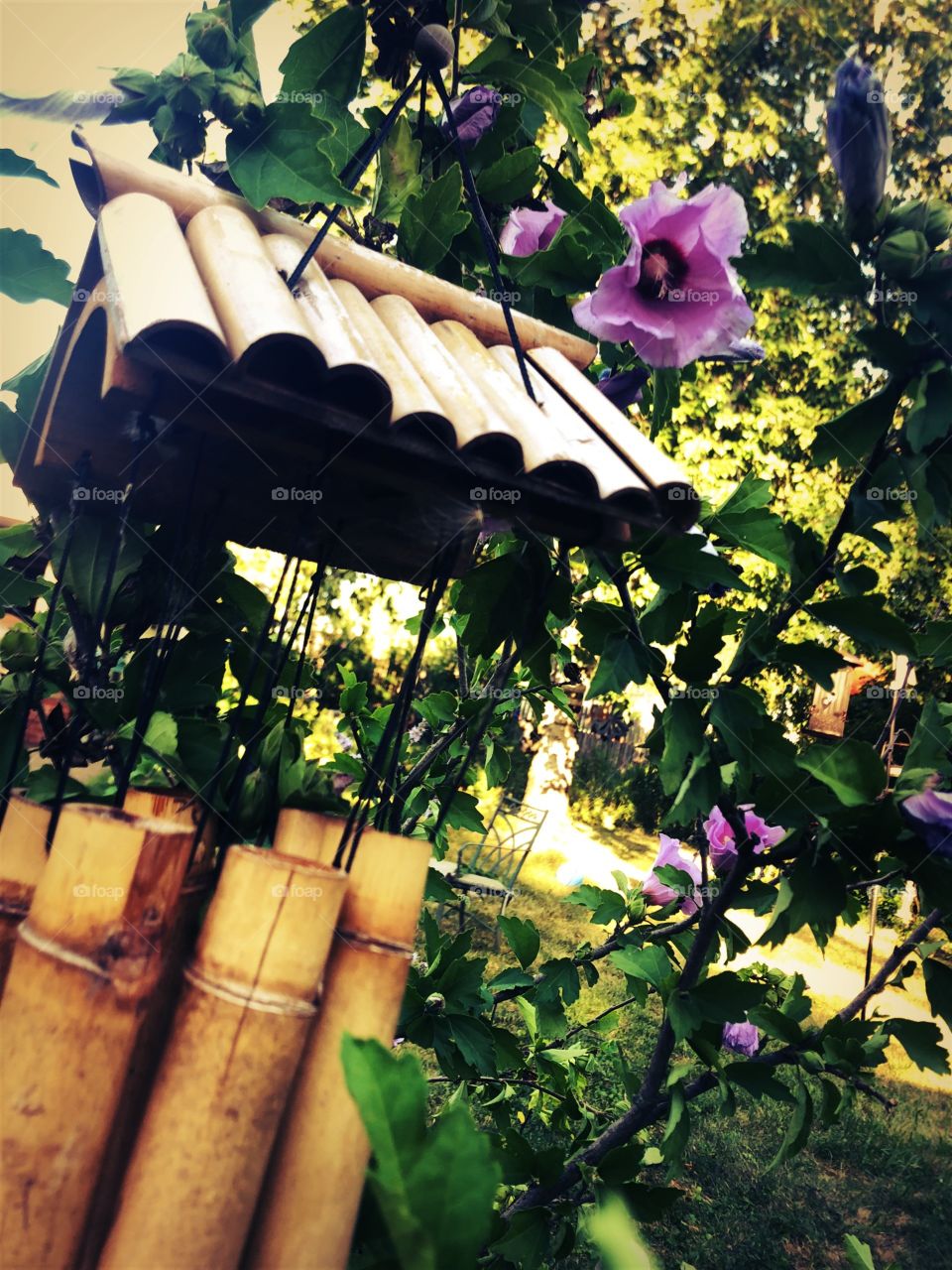 The breeze twists the wind chimes into a song. 
