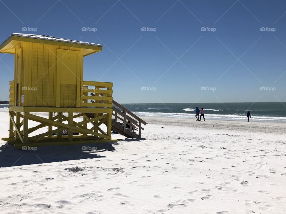 Bright yellow on white sandy beach 