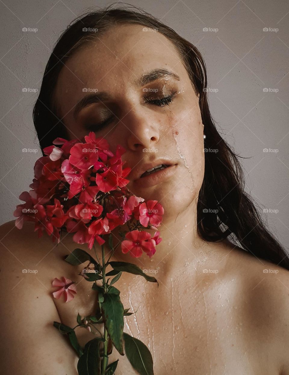 Portrait of a girl with a viva magenta flower