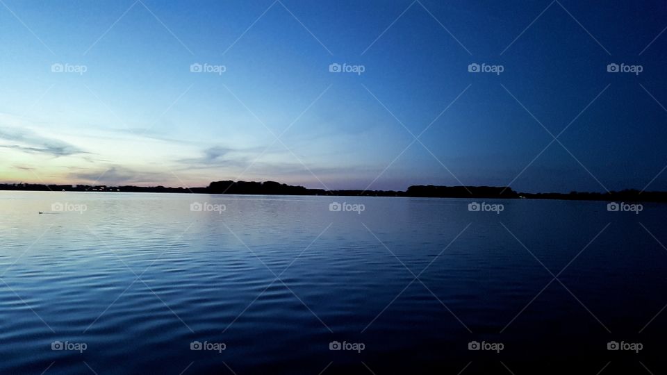 Beautifull sunset lake. dark blue