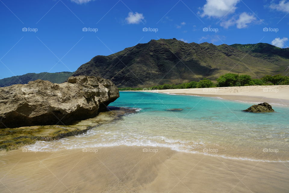 Gorgeous secret beach on the west side of Oahu. Turquoise waters and mountains make for a beautiful Oceanside view 