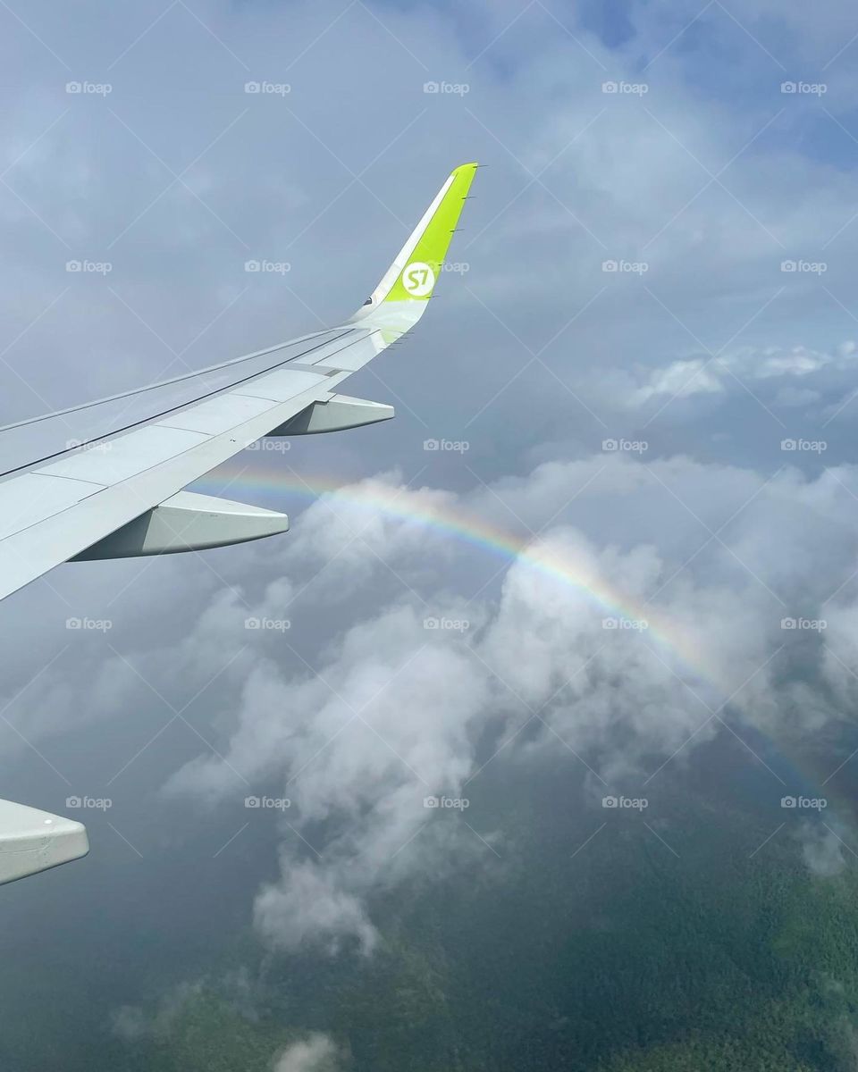 Rainbow in front of an airplane wing