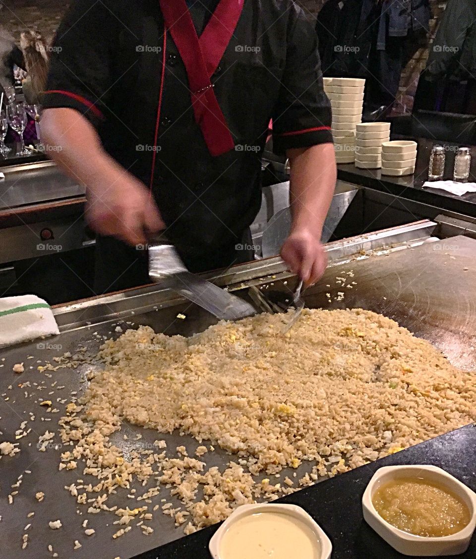 Chef at hibachi grill preparing fried rice.  It’s a lot of rice but it’s for the whole table. 