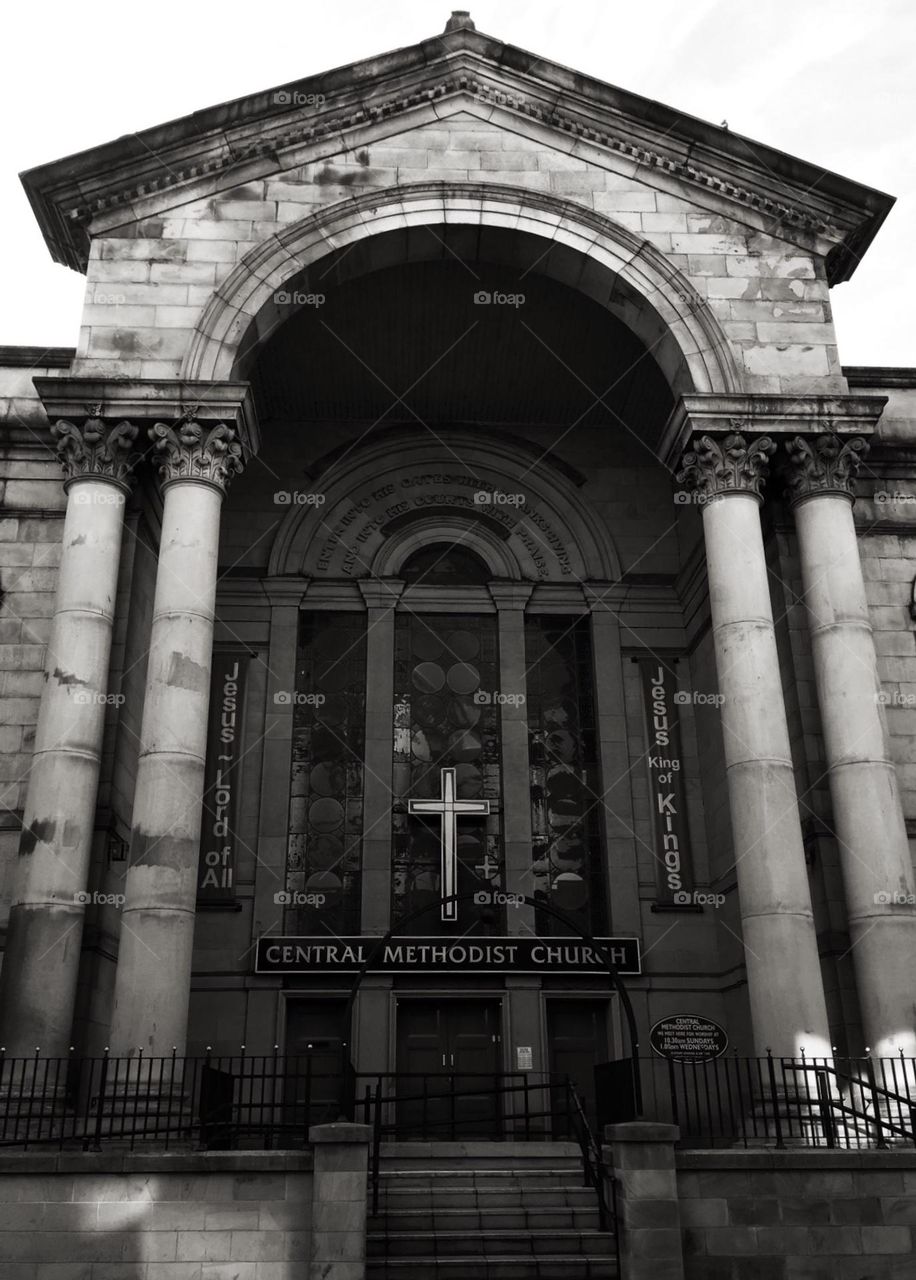 Outside of a church, doors to a church, crosses on a church, black and white building, architecture of a building 