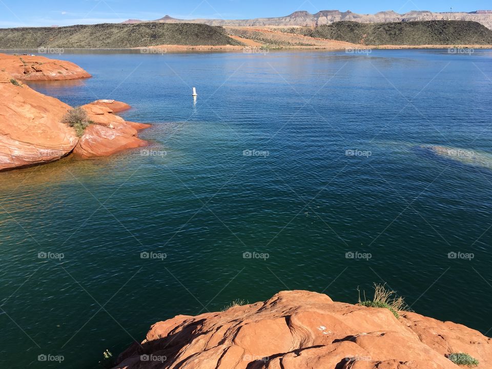 Blue water surrounded by red rocks 