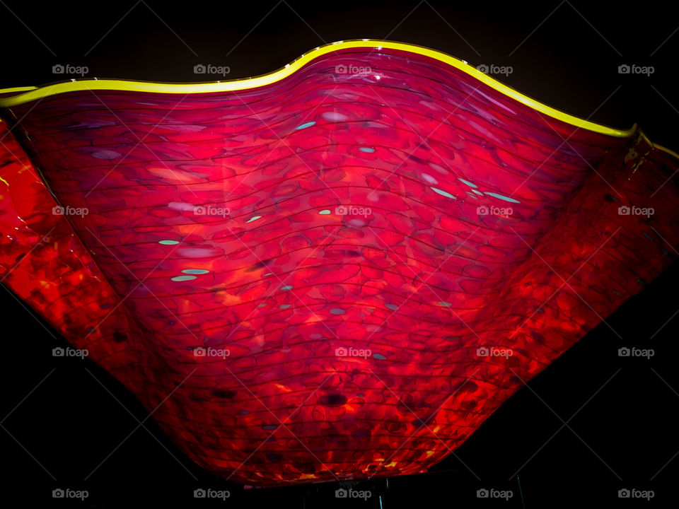 Red and yellow bright, color Chihuly glass bowl at the Chihuly glass museum in Seattle Washington. 