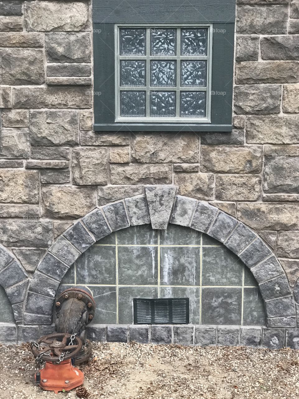 Details of the old stone pump house on the shores of the Deschutes River in Bend in Central Oregon on a summer day. 