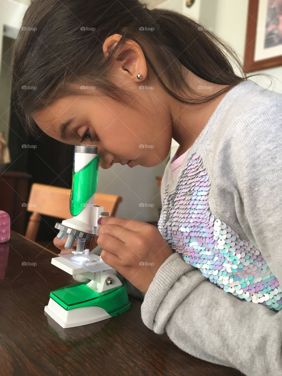 girl looking in microscope