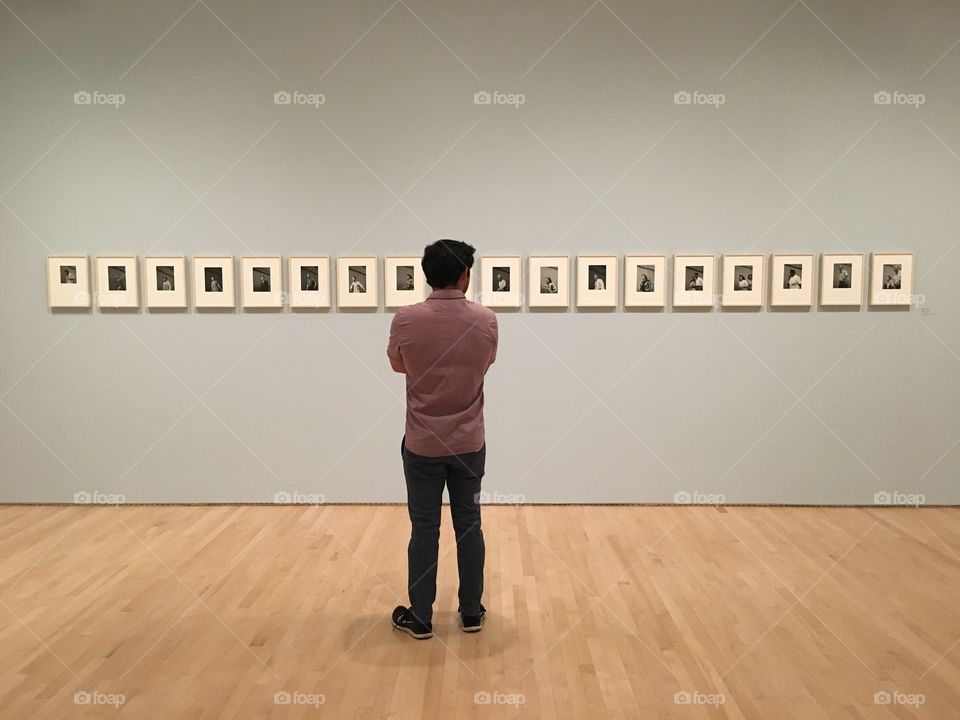 Guy viewing art in gallery