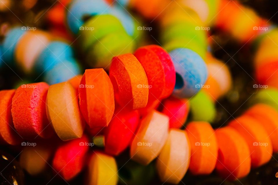 Up close and personal macro of a favorite of childhood, the colorful and delicious candy necklace , sweet and tart