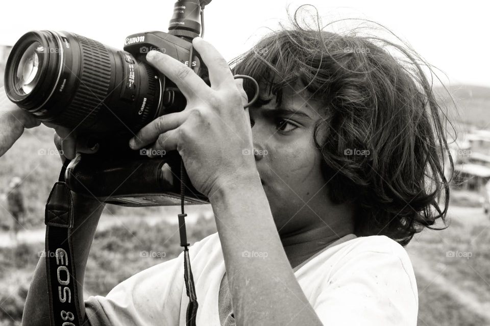 black and white photo of a small boy getting to know the world of photography