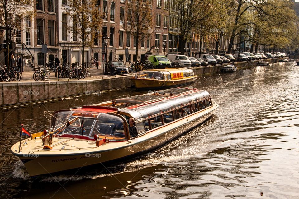 a tour boat trough the canals of amsterdam