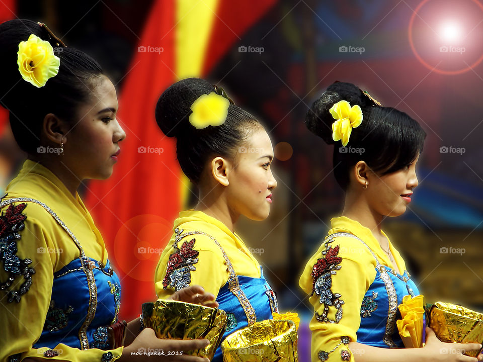 Close-up of dancers with yellow costumes