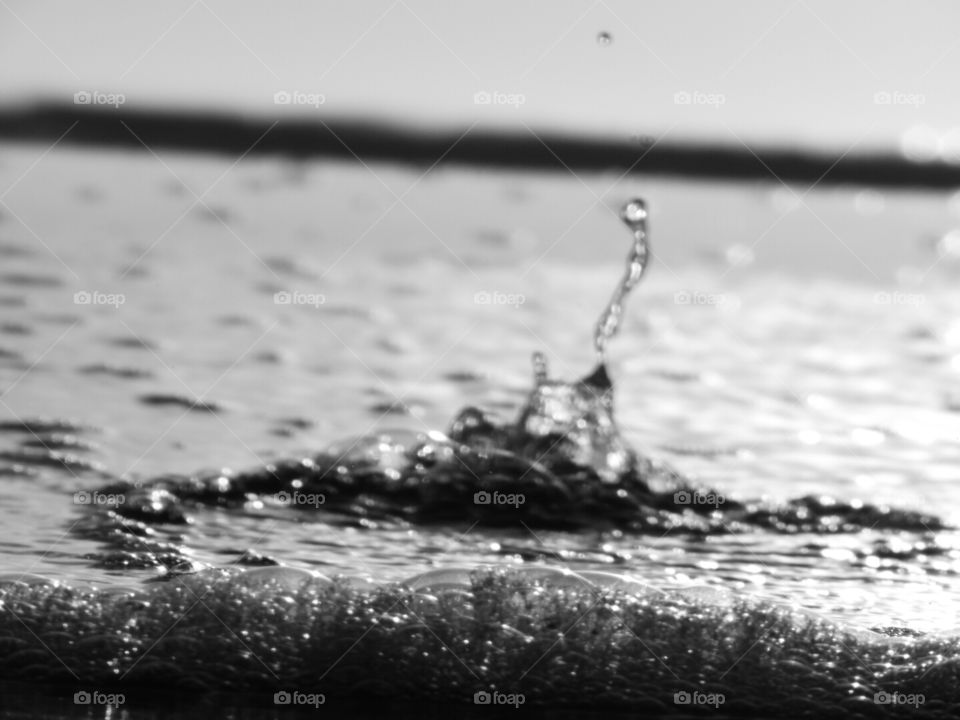 Water in motion as it bubbles up through the sand.