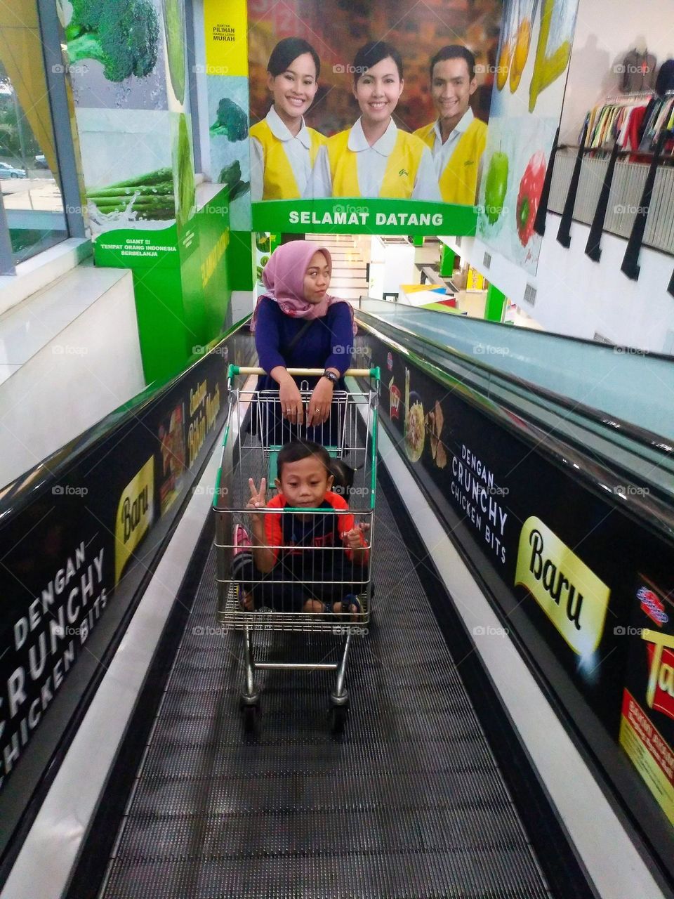 A mother and daughter on a travelator at the mall