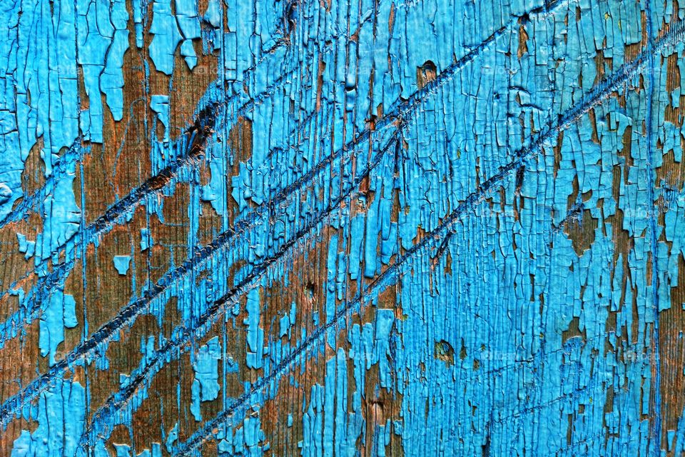 Vintage wooden background of blue color. Deep scratches on wooden plank blue background