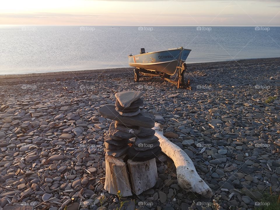 An inukshuk in the pebble beach at Manche d'épée, Gaspésie, Québec, Canada.