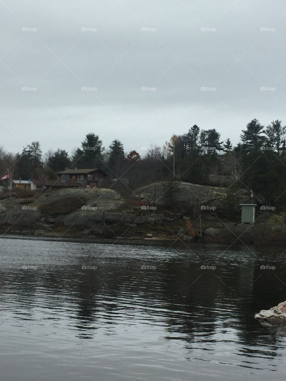 A nice view from across the lake to the cottage perched high on a rock northern Ontario