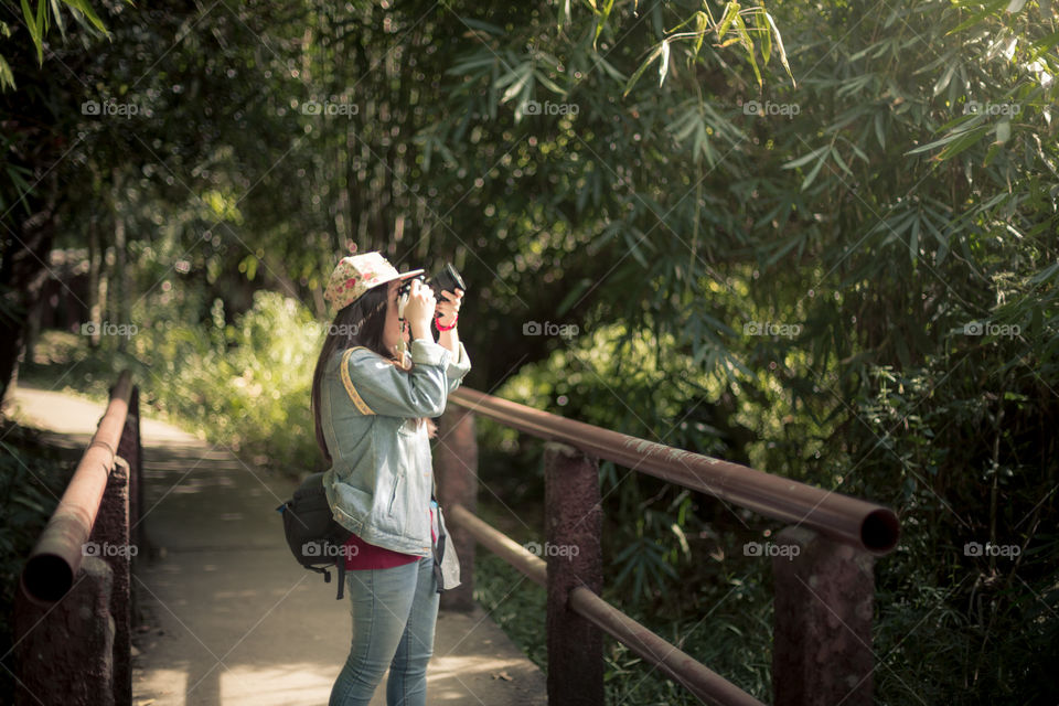 Female tourist taking a photo on the bridge