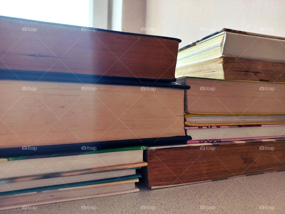 stacked books resemble rectangular brick buildings.