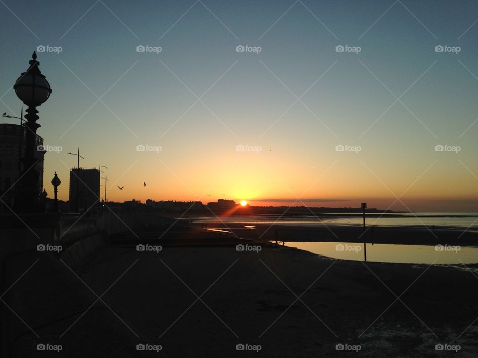 I took this beautiful sunset in Margate, Kent, UK, as I walked along the deserted beach towards the harbour, where the boats sat on the sand marooned as the tide was out.