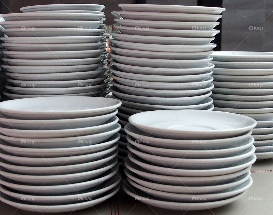 Stacks of empty white plates