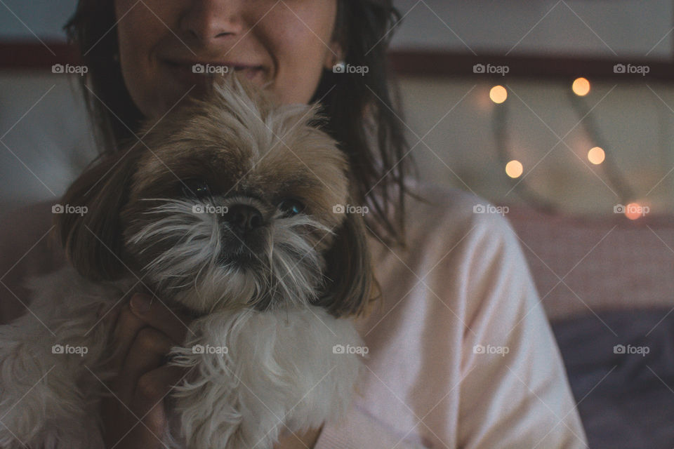 Girl hugging her cute shihtzu dog