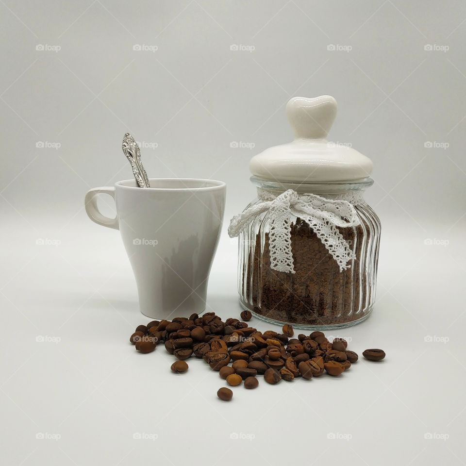 jar filled with coffee and roasted coffee beans on white background, mug