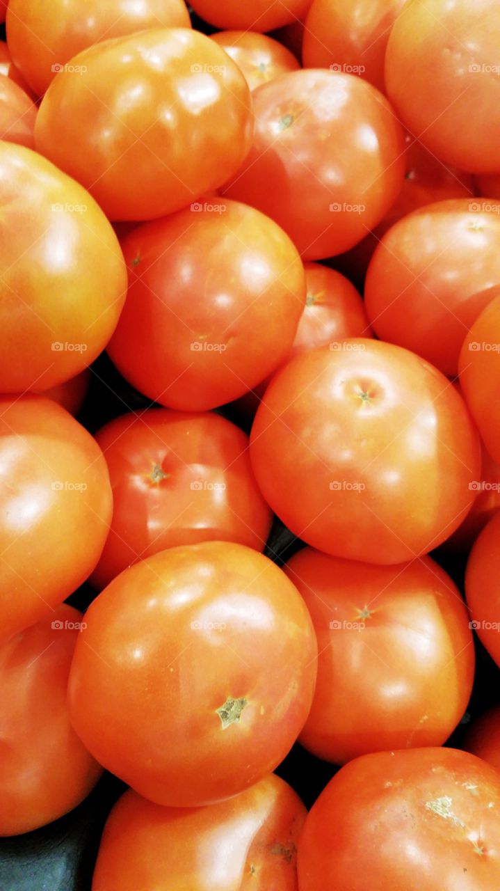 Some freshly harvested red tomatoes on display in a local market.