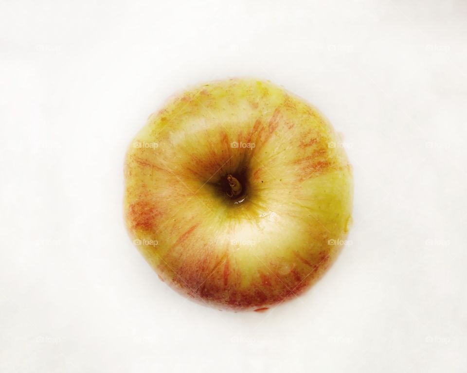 Freshly washed apple on a white background