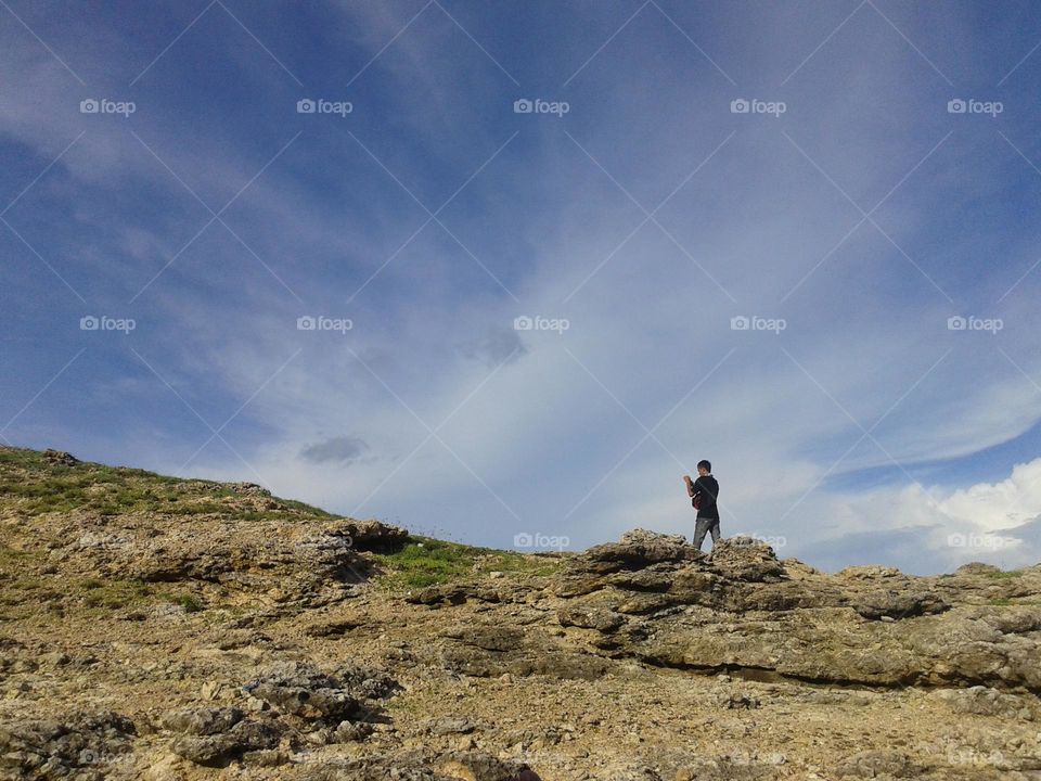 mountain peak with white clouds in blue sky