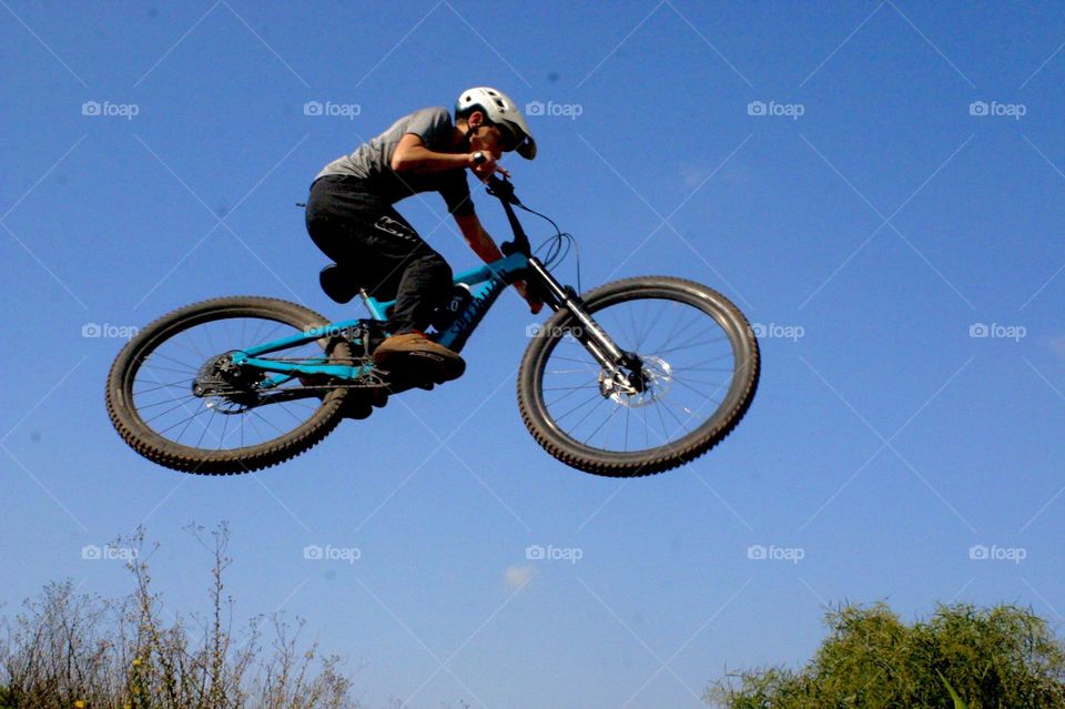 Kid jump with his bicycle high in the air