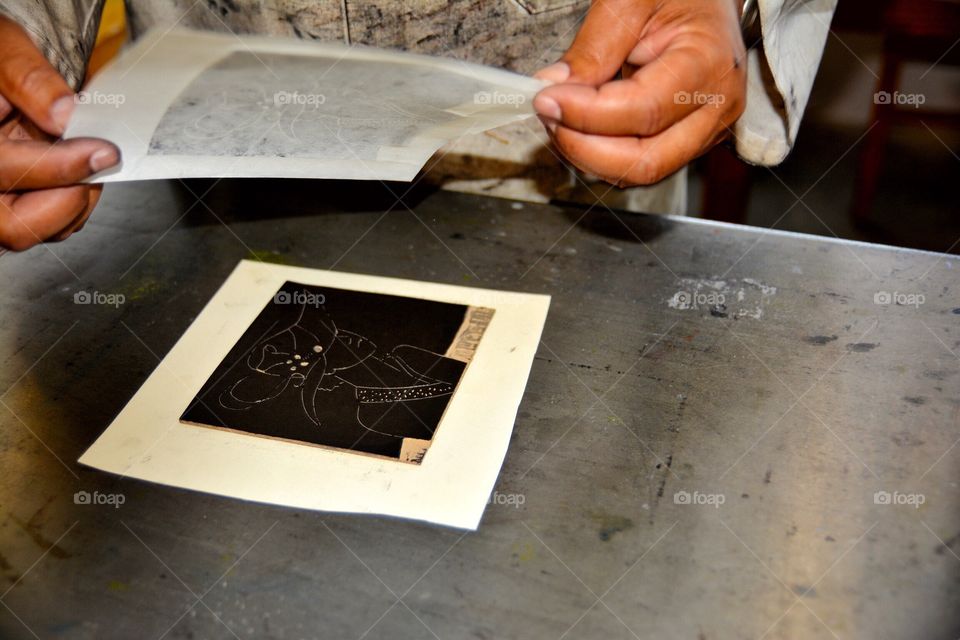 Man making ink block prints