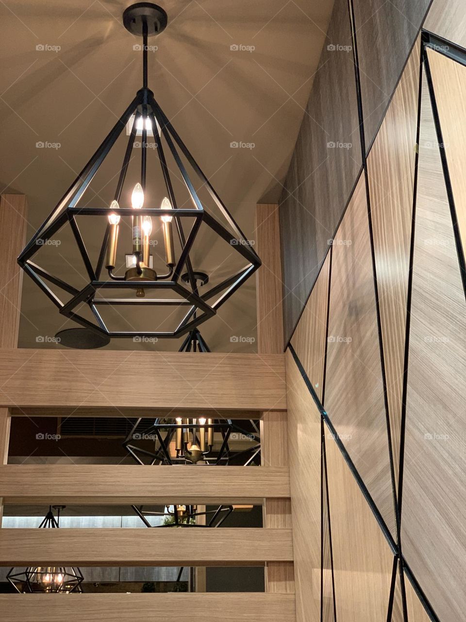 Lights on hexagonal design and triangular wood wall inside the restaurant New York.