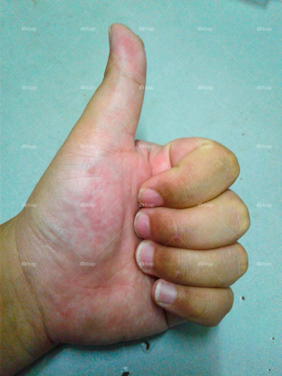 Close-up of human's hand showing thumbup