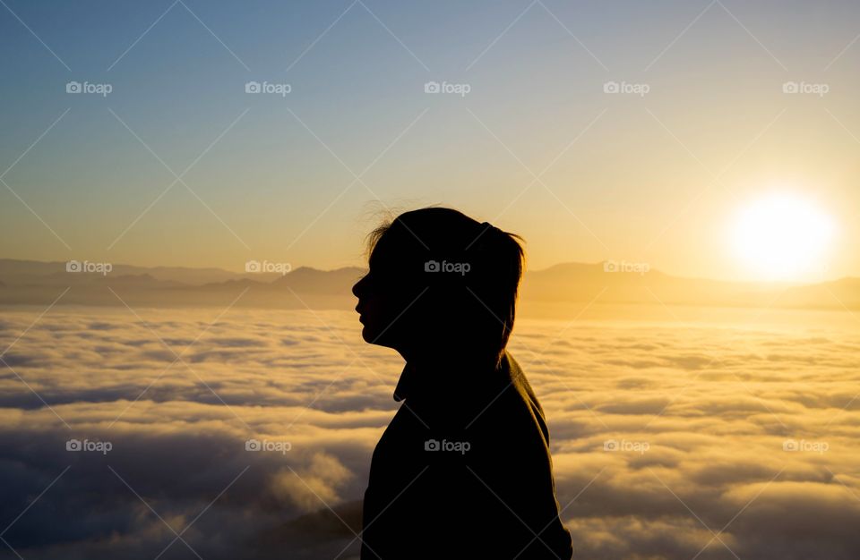 silhouette of a woman in the mountains during sunrise