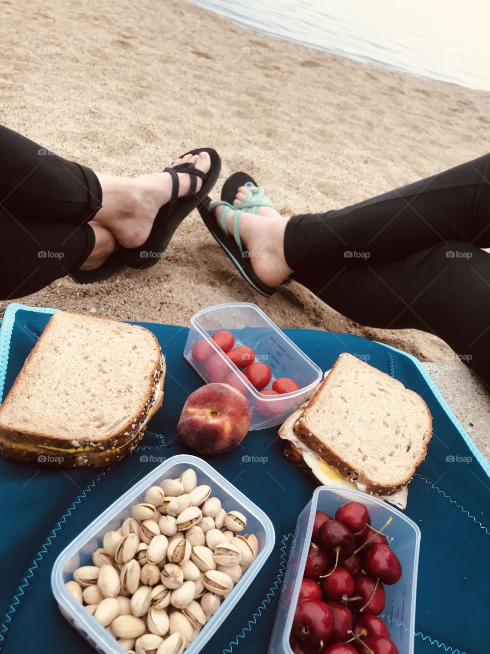 This is how we like to eat...sitting at the beach with our sandwiches, tomatoes, cherries, pistachios, and a peach! So relaxing!! 