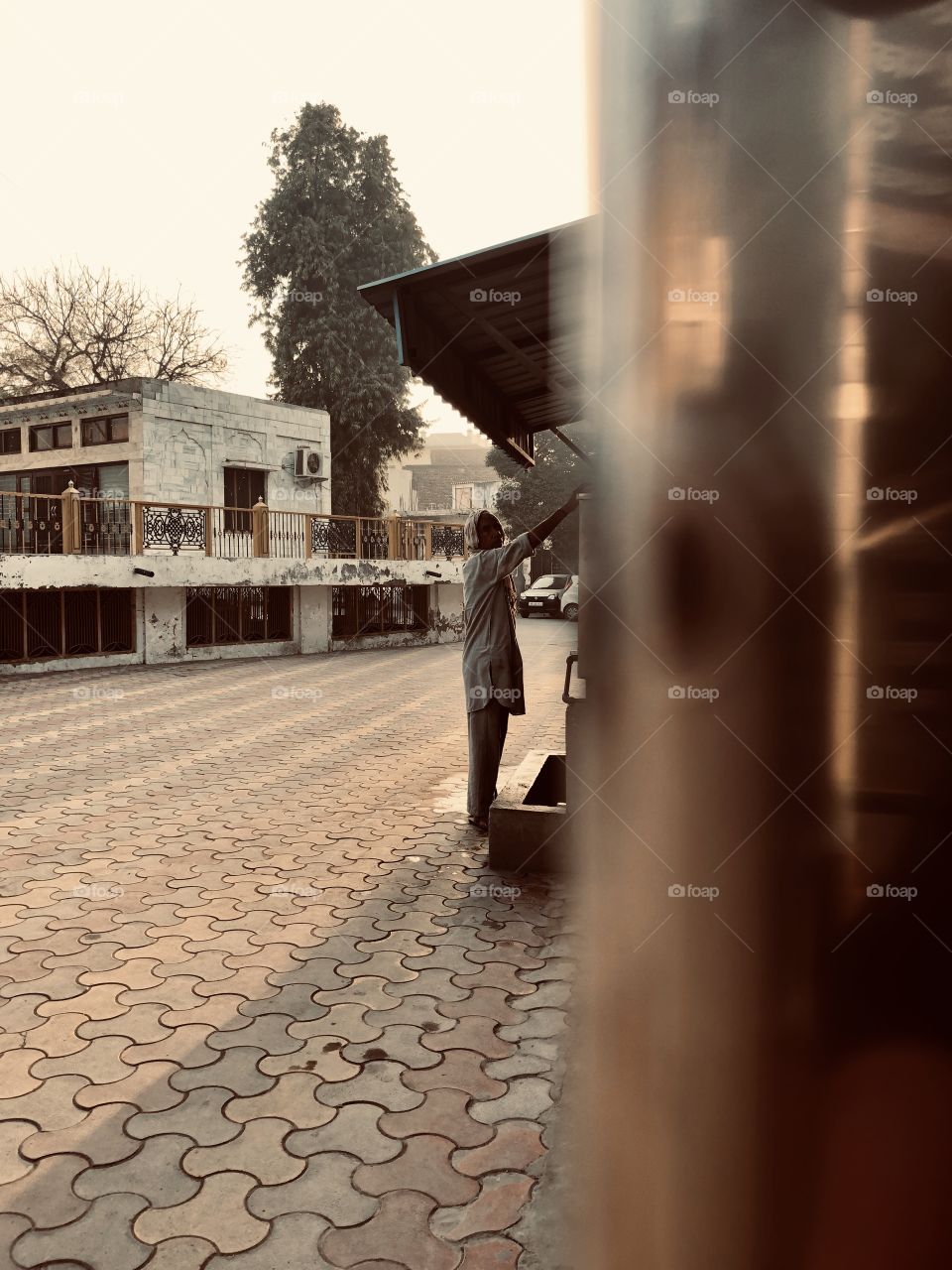 Man washing his hands before entering the temple 