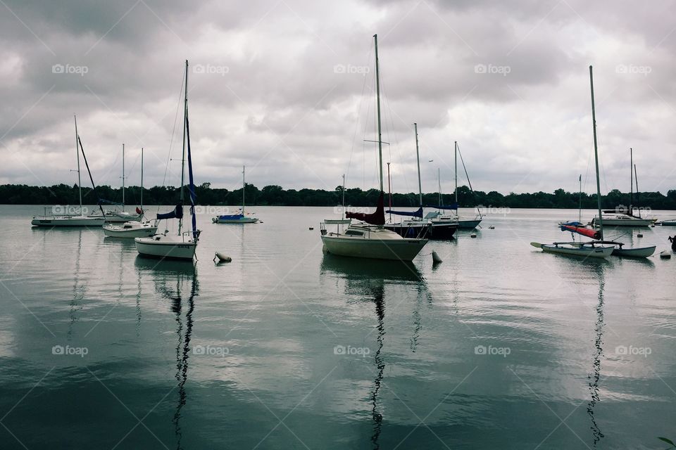 Sailboats moored on lake