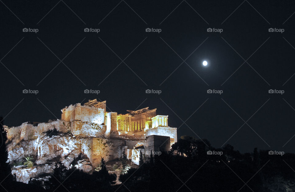 Acropolis with full moon. The Acropolis of Athens lit up and a "blue" moon in the background. 