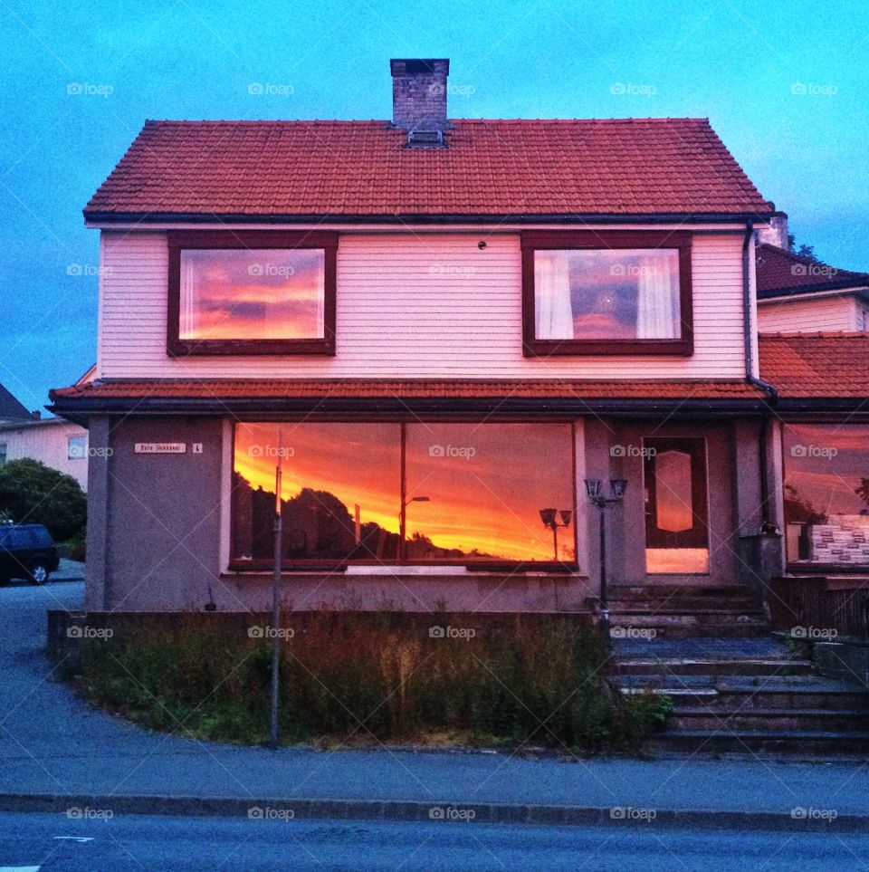 House front with sunset reflection