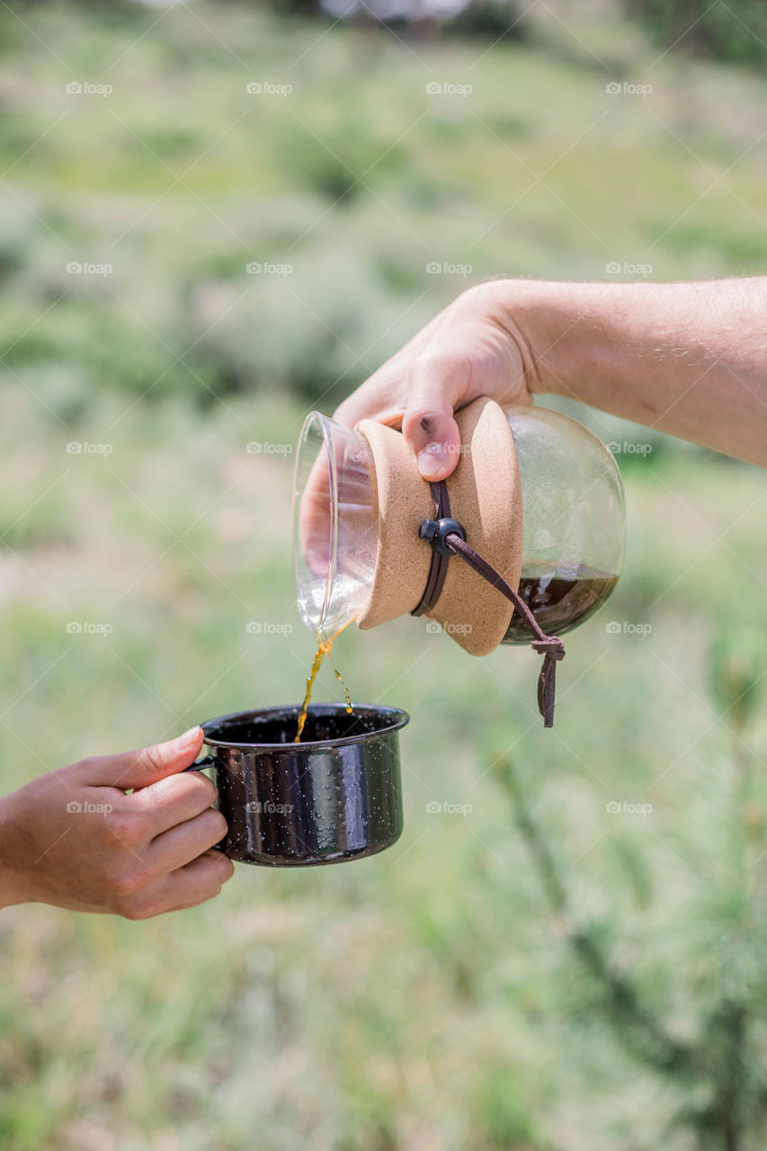 Pouring coffee on black mug