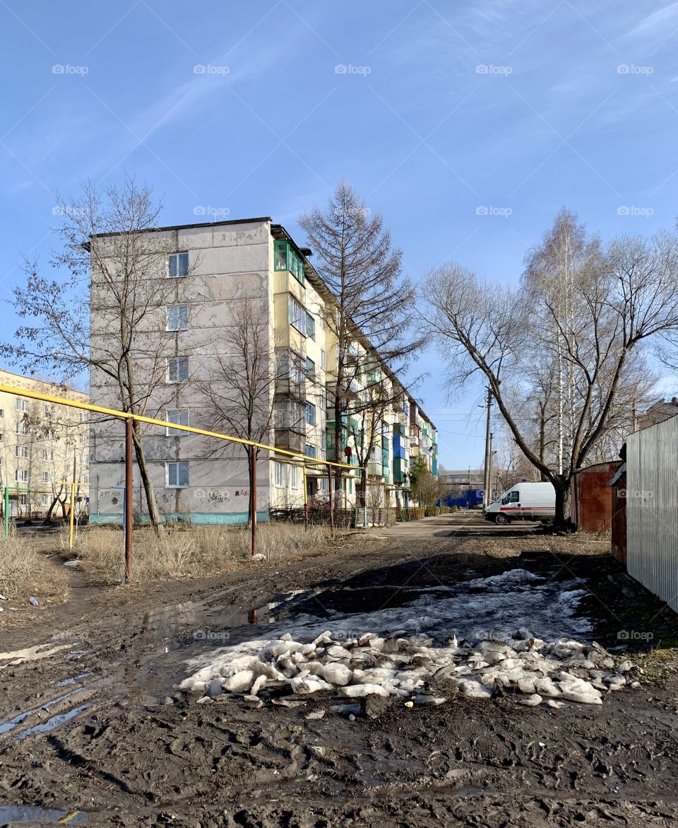Early Spring. it can also be different. first signs of spring. Snow is melting. Thawed thaw. Dirt and puddles on the roads. But the beautiful blue sky above the head