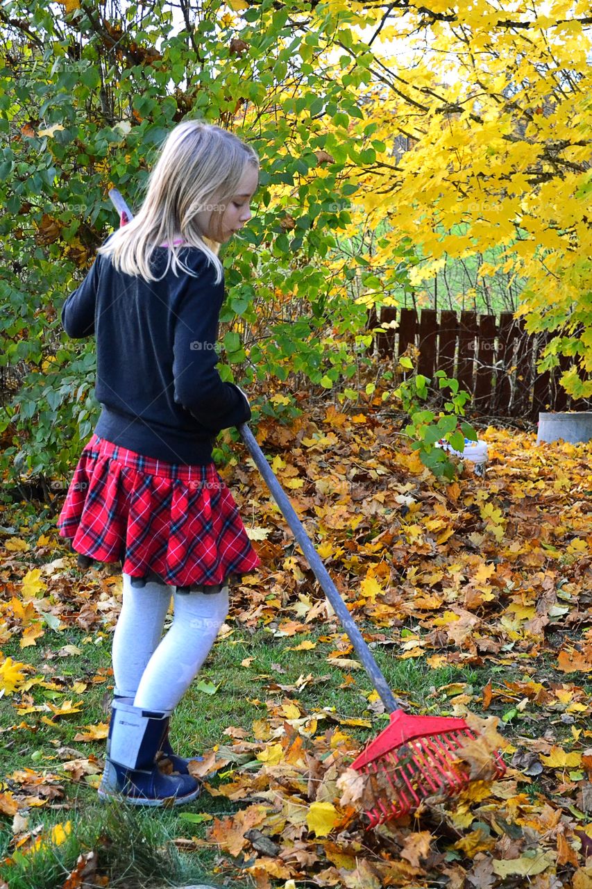 Girl raking leaves